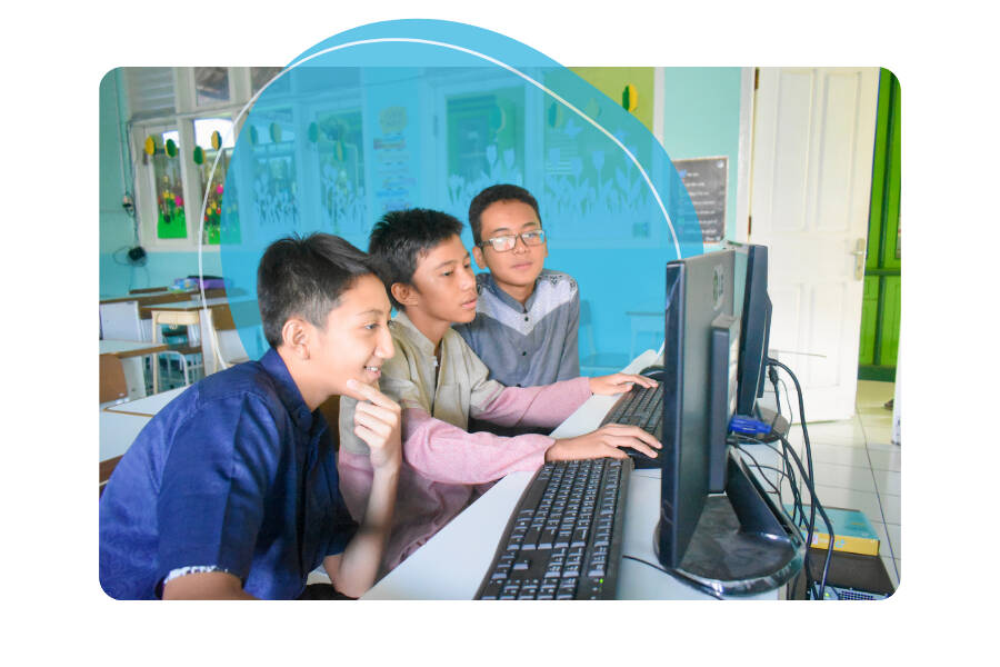 Three students using a computer